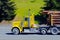 Bright yellow big rig semi truck cargo logs