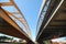 Bright yellow bridge named Hogeweidebrug over the Amsterdam-Rhine canal in Utrecht for traffic and Vleutenspoorbrug which is a tra