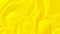 Bright yellow crumpled wrinked paper texture background