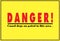 A bright yellow danger sign warning about dogs on patrol. The fonts are red and black in color.