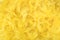 Bright yellow feathers in a full frame image as background for easter or softness