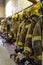 Bright yellow fire fighter helmets and jackets at a fire station house