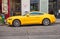 Bright yellow Ford Mustang 2015 car stands in city