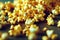 Bright yellow grains of crispy caramel popcorn scattered across wooden table.