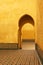 Bright yellow islamic arches and patios in Meknes, Morocco