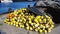 Bright yellow and orange fishing buoys and fish net piled at the fishing harbor, Port of Los Angeles, California.