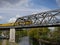 Bright yellow passenger train crossing a bridge