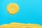 Bright Yellow Sun Seashore Sand on Light Blue Background Made from Dry Uncooked Polenta. Summer Vacation Beach Concept