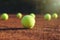 Bright yellow tennis ball on clay court