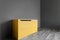 Bright yellow vintage chest of drawers in the room