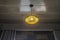 Bright yellow vintage hanging light bulb in master bedroom ceiling