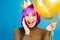 Brightful positive emotions at celebrating new year, birthday party of funny joyful young woman with cut purple hair on