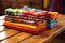 brightly colored african textiles folded neatly on wooden table