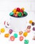 Brightly Colored Candied Popcorn, white background. Horizontal image of Junk food, fruit flavored popcorn in old metal cup. Colorf