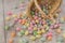 Brightly colored Easter Egg Candy spilling from wicker basket