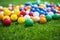 brightly colored golf balls scattered on green turf