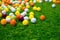 brightly colored golf balls scattered on green turf