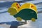 A brightly colored green and yellow rocking turtle at a public playground. Activity toy in the park, kindergarten or school yard