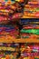 Brightly colored handwoven textiles stacked on a shelf in Merida, Mexico