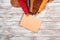 Brightly colored leather in rolls and notebook on white wooden background. Leather craft. Copy space. Top view.