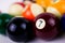 Brightly colored pool or billiard balls close up on white background