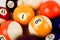 Brightly colored pool or billiard balls close up on white background