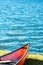 Brightly colored red canoe lakeside