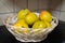 Brightly colored ripe mangoes in a fruit basket