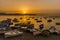 Brightly coloured fishing boats on the beach at Aspra Sicily as the sun goes down