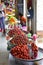 Brightly coloured pickled Chinese Dates sold with other fruits by Vendor along the outdoor corridor of Bogyoke Market