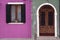 Brightly coloured pink and green house wall in Burano where houses with shutters and doors are painted in beautiful colours Burano