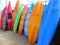 Brightly coloured stacked kayaks