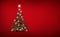 Brightly decorated Christmas tree isolated on red  background