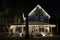 Brightly illuminated christmas decorations on front yard porch of florida family home. Outside decor for winter holidays