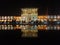 The brightly light up Ali Qapu Palace at night with reflection at pool.