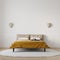 Brightly lit bedroom with vibrant gold color bedspread, mock-up with negative space