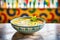 brightly lit bowl of soup with a creamy swirl pattern