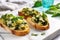 brightly lit shot of spinach and artichoke bruschetta on a cool marble countertop