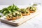 brightly lit shot of spinach and artichoke bruschetta on a cool marble countertop