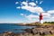 brightly painted lighthouse under sunny skies