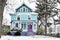Brightly painted Victorian House Covered in Snow