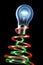 Brightly shining light bulb with electrons flow.