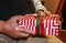 Brightly wrapped Christmas present in hands of older man - closeup and selective focus