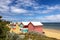 Brighton beach Victorian bathing boxes. Brightly painted colourful beach huts line the sand in Melbourne, Australia.