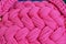 Brigt pink crocheted pattern, pink handmade background, creativity concept, glamour color, details of a handmade crocheted handbag