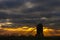 Brill mill silhouetted under dramatic skies