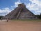 Brilliant ancient pyramid and tourists in Chichen Itza mayan town in Mexico, ruins at archaeological site