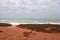 Brilliant ancient red rock formations at James Price Point, Broome, North Western Australia on a cloudy summer day.