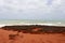 Brilliant ancient red rock formations at James Price Point, Broome, North Western Australia on a cloudy summer day.