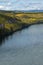 Brilliant autumn colors line the powerful Liard River